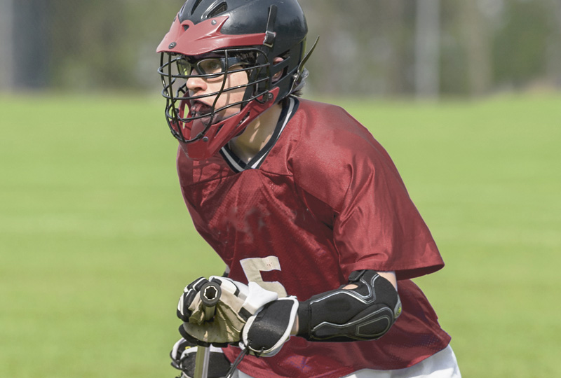 Lacrosse player wearing sports wrap glasses