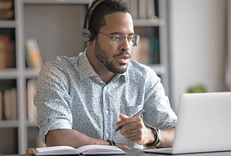 young man wearing glasses while on a video conference