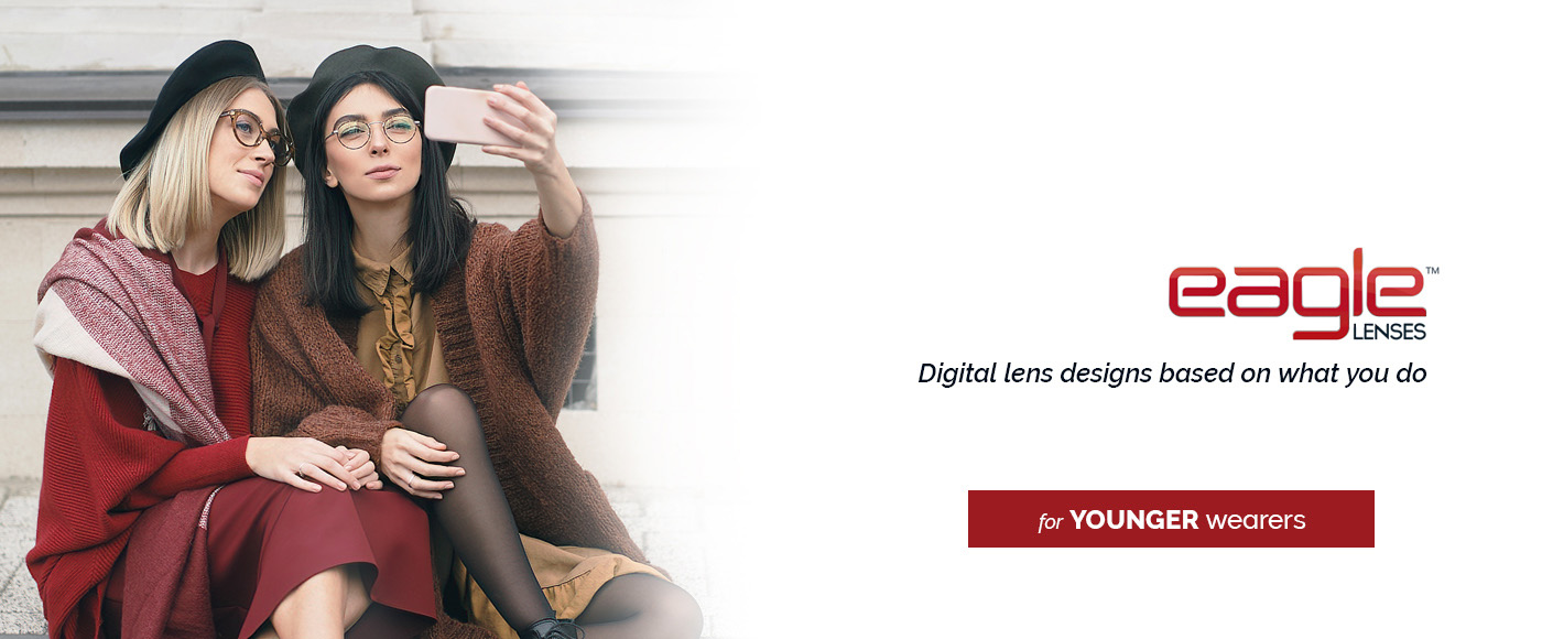 eagle lenses banner for younger wearers two young women dressed in fashionable fall attire, sitting and taking a selfie together
